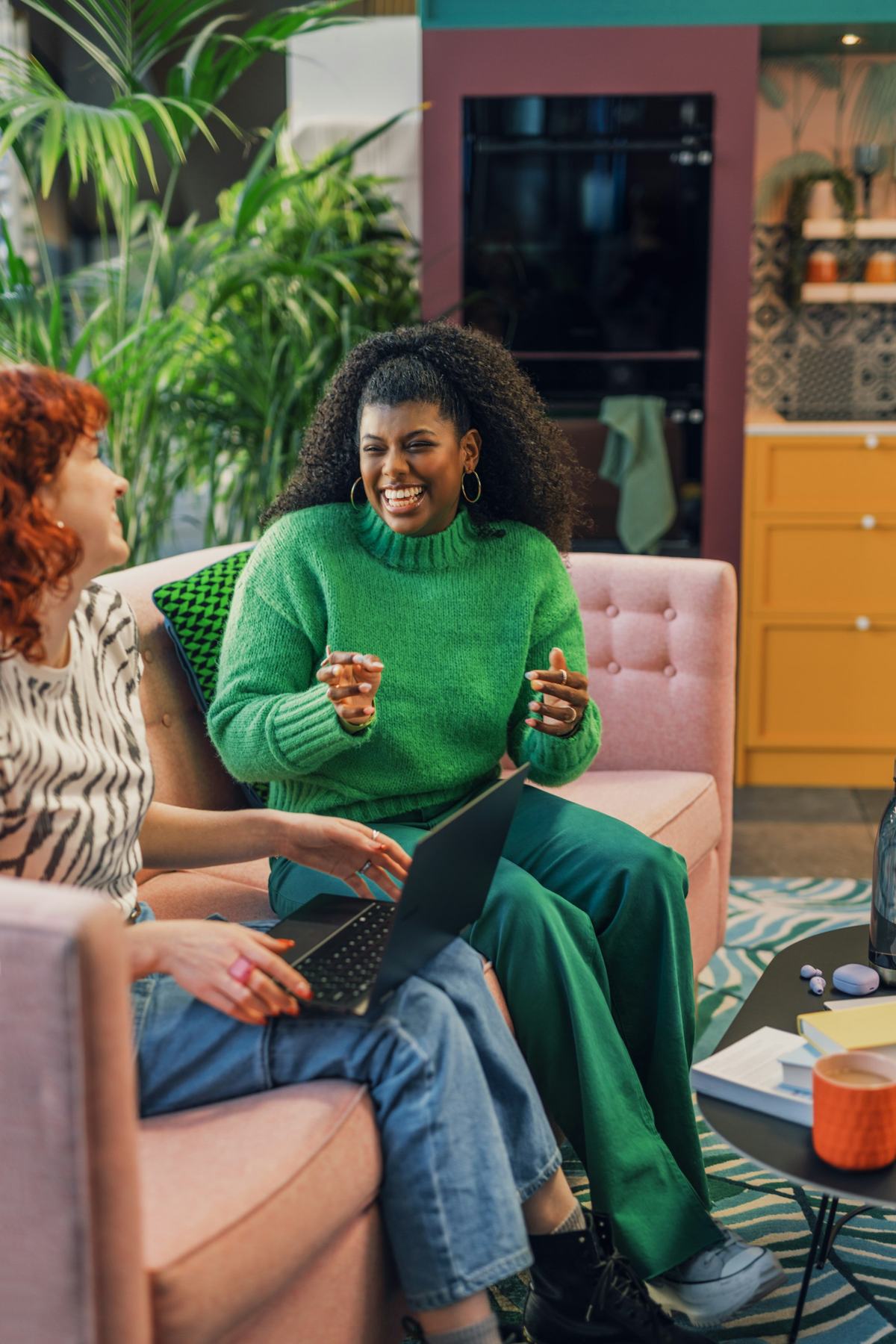 Two colleagues working together on a sofa